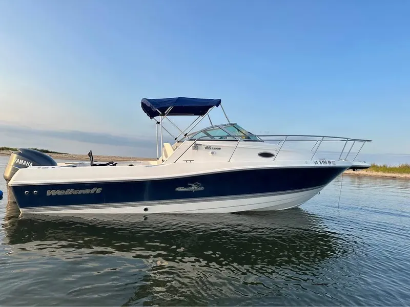 The Image of 2004 Wellcraft WALK AROUND boat on calm water. - 0