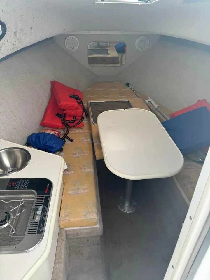 Slide: The Image of Interior of a 2004 Wellcraft WALK AROUND boat with table and kitchenette. - 5