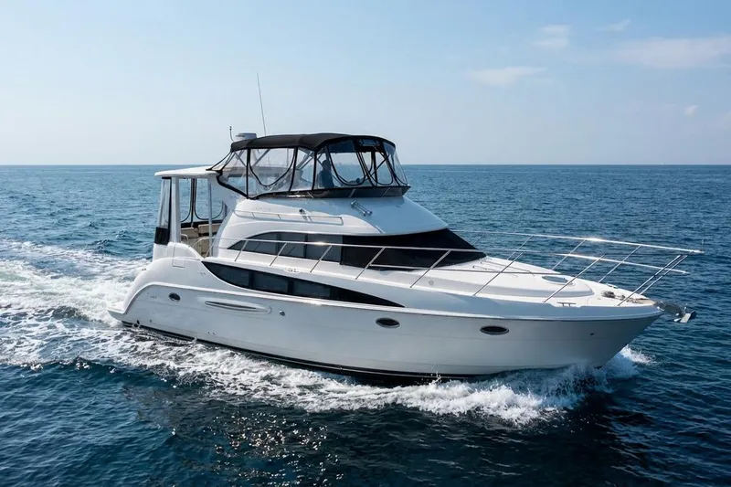 Slide: The Image of 2005 Meridian 459 Motoryacht cruising on open sea under clear skies. - 1