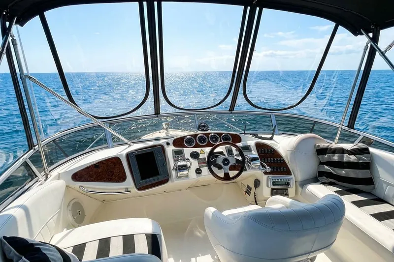 Slide: The Image of Luxurious 2005 Meridian 459 Motoryacht helm with ocean view and plush seating. - 16