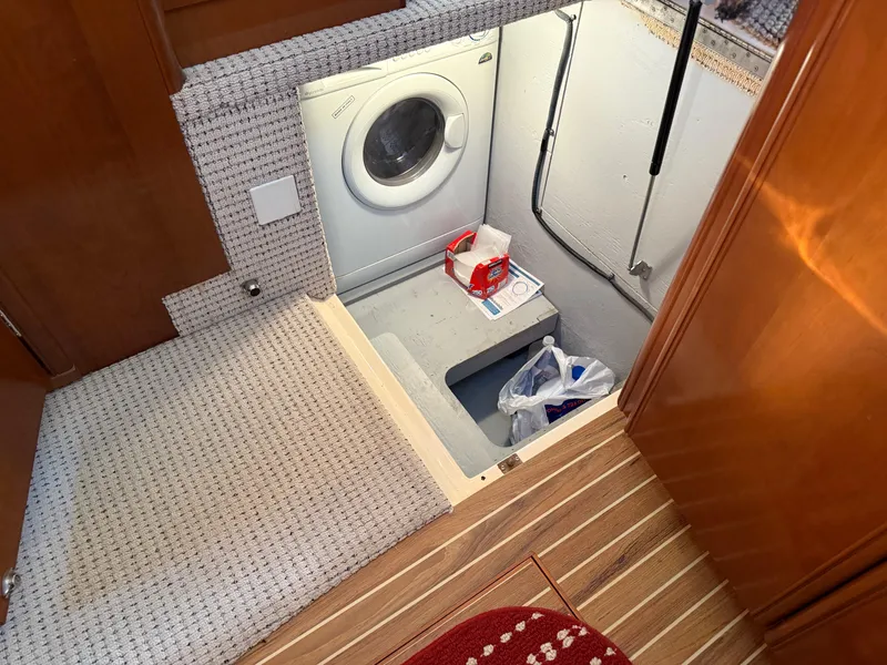 Slide: The Image of Laundry area in 2005 Meridian 459 Motoryacht with washing machine and storage space. - 36