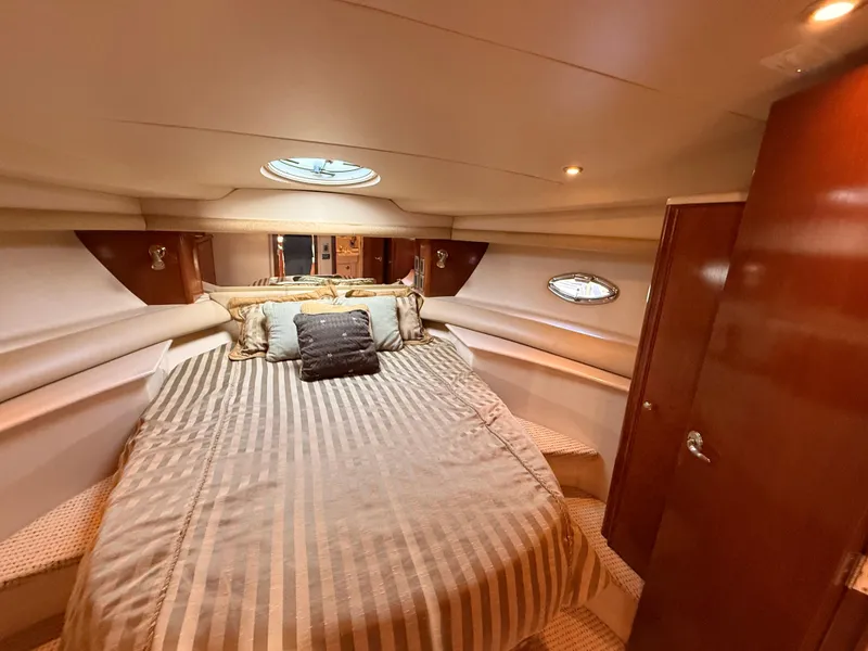 Slide: The Image of Luxurious bedroom interior of 2005 Meridian 459 Motoryacht with striped bedding and porthole windows. - 39