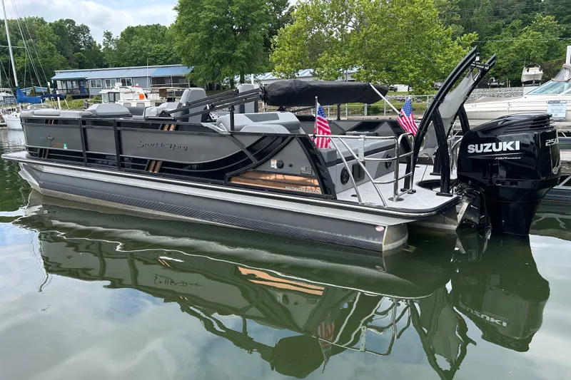 The Image of 2025 South Bay 525UL393 pontoon boat docked with Suzuki outboard motor. - 0