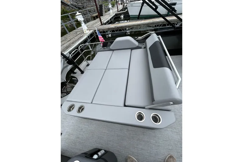Slide: The Image of Luxury seating on 2025 South Bay 525UL393 boat, featuring sleek gray upholstery and cup holders. - 30
