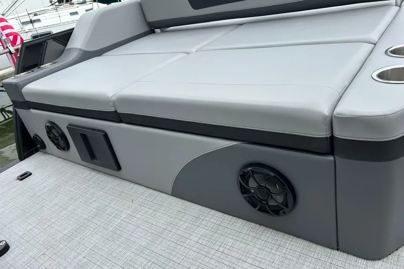 Slide: The Image of Luxurious seating on 2025 South Bay 525UL393 boat with integrated speakers and cup holders. - 34