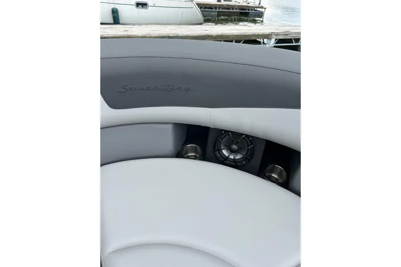 Slide: The Image of 2025 South Bay 525UL393 boat interior with speaker and cup holder. - 38
