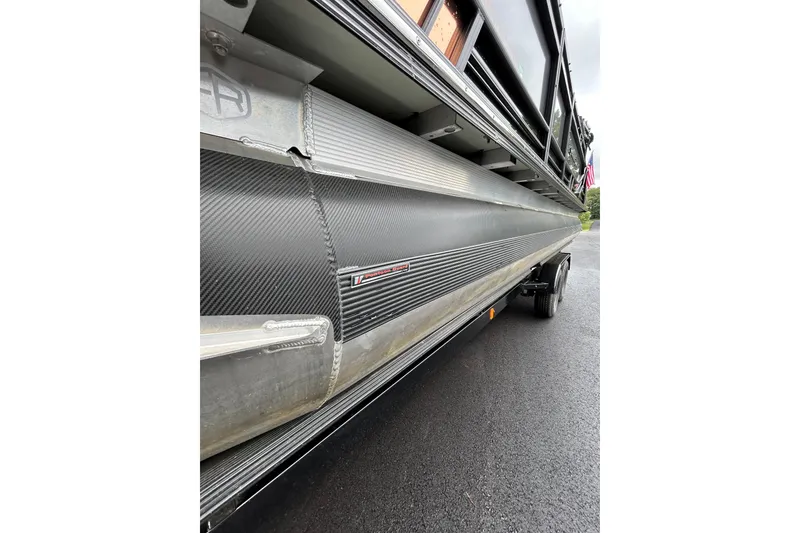 Slide: The Image of 2025 South Bay 525 Tritoon pontoon boat on trailer, showcasing sleek design and durable construction. - 48