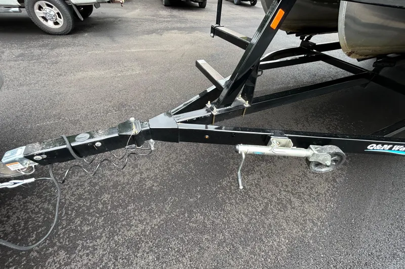 Slide: The Image of Trailer hitch of 2025 South Bay 525 Tritoon on asphalt surface. - 49