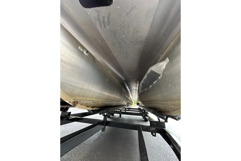 Slide: The Image of Underneath view of a 2025 South Bay 525 Tritoon boat on a trailer. - 50