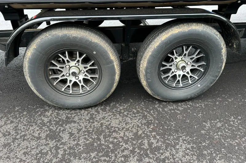 Slide: The Image of Trailer wheels of a 2025 South Bay 525 Tritoon on asphalt surface. - 52