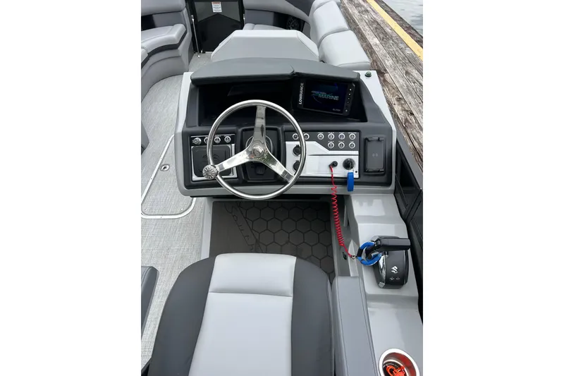 Slide: The Image of 2025 South Bay 525UL393 boat dashboard with steering wheel and control panel. - 18