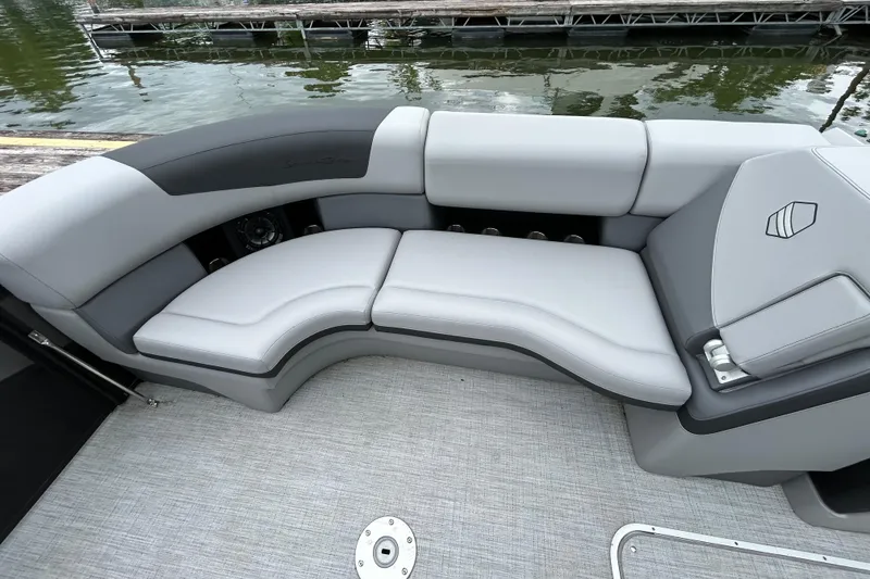 Slide: The Image of Luxurious seating on 2025 South Bay 525UL393 pontoon boat, docked by the water. - 27