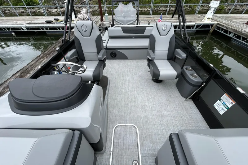 Slide: The Image of 2025 South Bay 525UL393 pontoon boat interior with modern seating and steering wheel. - 29