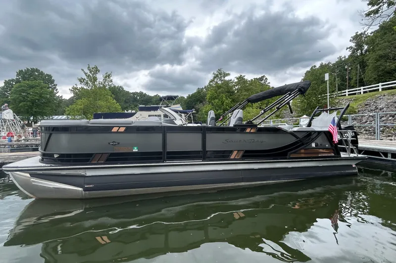 Slide: The Image of 2025 South Bay 525UL393 pontoon boat docked on a cloudy day. - 9