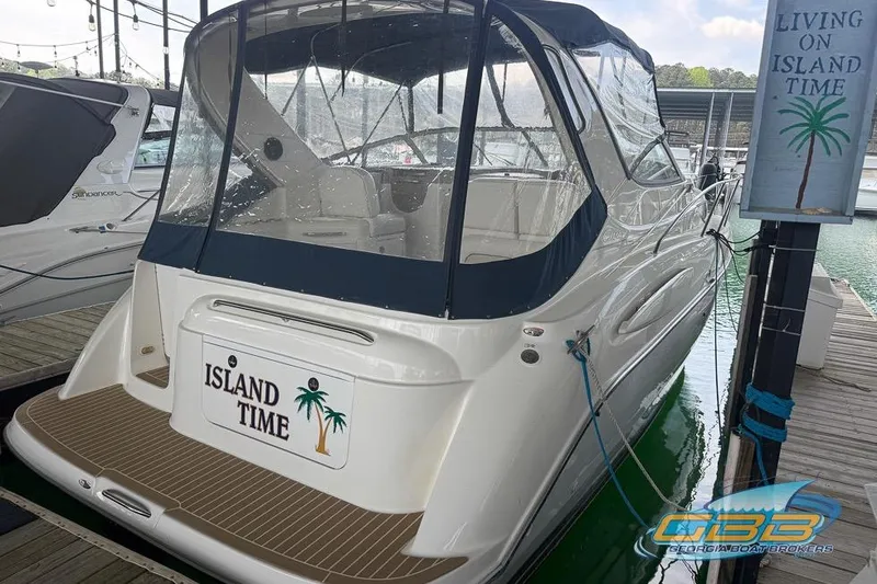 The Image of 2002 Bayliner 3055 Ciera docked, named "Island Time," with clear canopy and marina setting. - 0