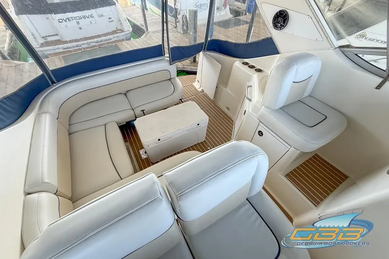 Slide: The Image of Interior of 2002 Bayliner 3055 Ciera boat with white seating and wood flooring. - 10