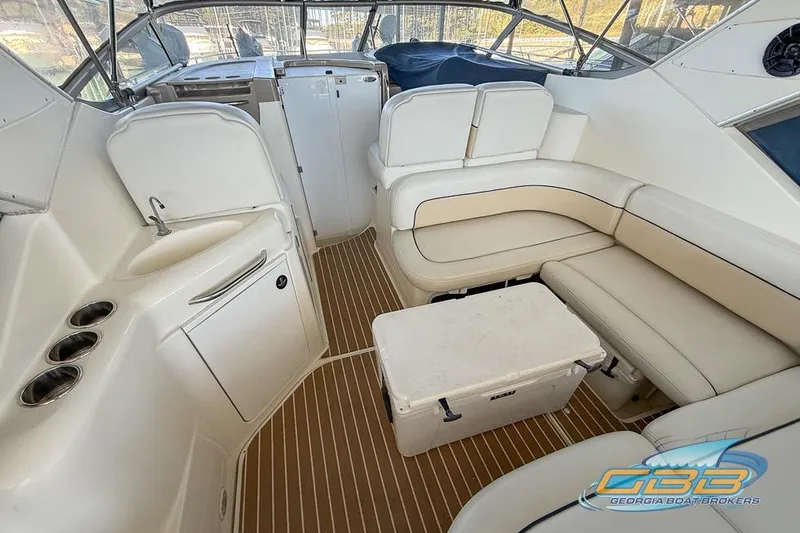 Slide: The Image of Interior of 2002 Bayliner 3055 Ciera boat with white seating and wooden flooring. - 11
