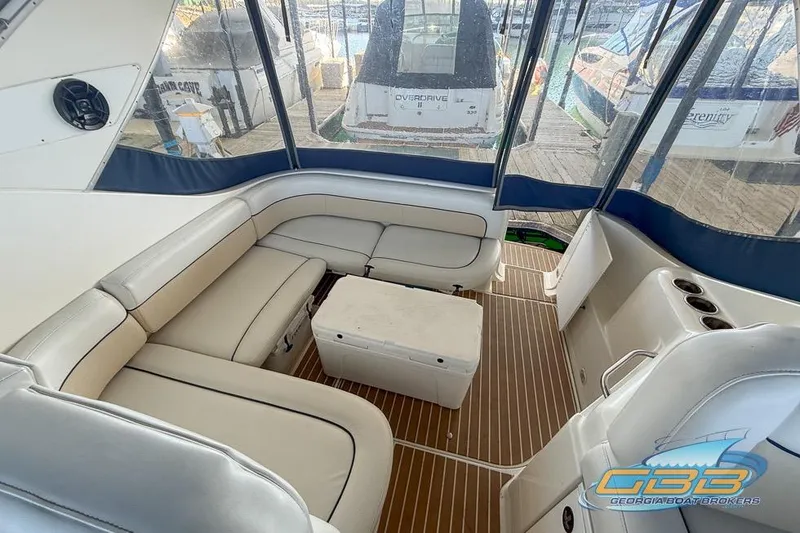 Slide: The Image of 2002 Bayliner 3055 Ciera interior with white seating and wooden flooring. - 14