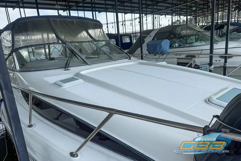 Slide: The Image of 2002 Bayliner 3055 Ciera docked in a marina, featuring sleek design and covered cockpit. - 16