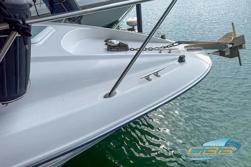 Slide: The Image of Bow of a 2002 Bayliner 3055 Ciera boat with anchor, docked on water. - 18