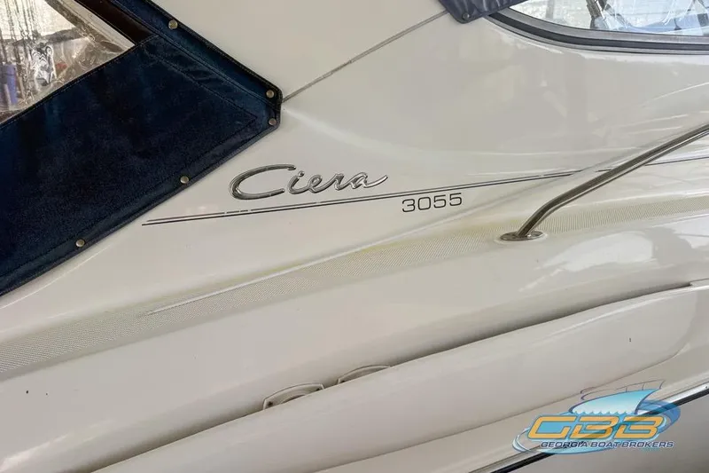 Slide: The Image of 2002 Bayliner 3055 Ciera boat side view with logo and railing. - 19