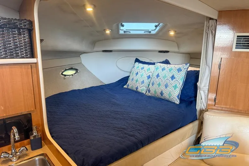 Slide: The Image of Cozy cabin interior of 2002 Bayliner 3055 Ciera with bed and pillows. - 4