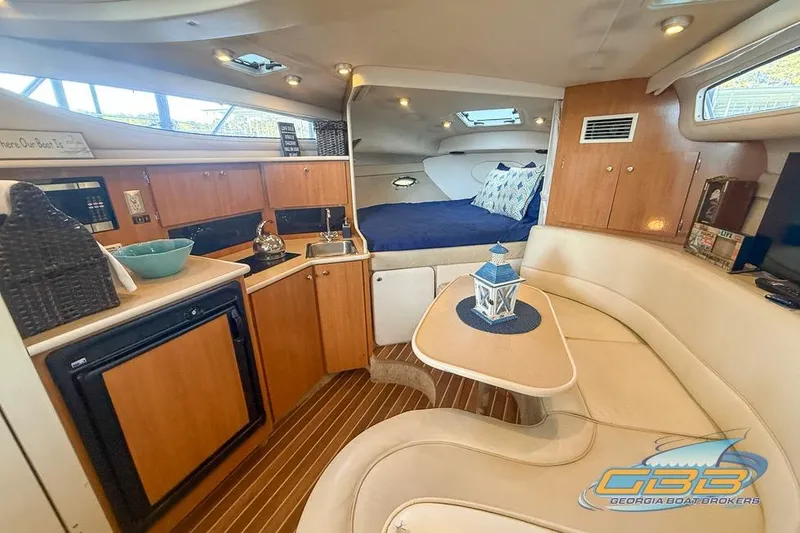 Slide: The Image of Interior of a 2002 Bayliner 3055 Ciera boat with kitchen and seating area. - 5