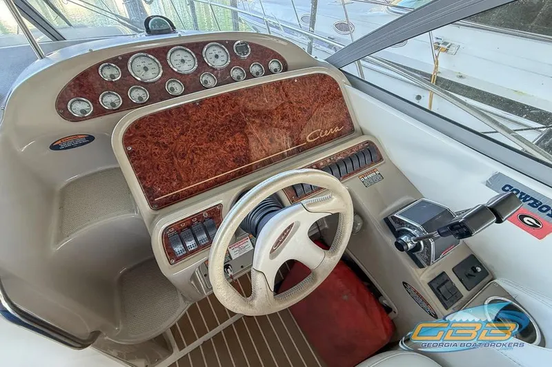 Slide: The Image of 2002 Bayliner 3055 Ciera helm with woodgrain dashboard and steering wheel. - 8