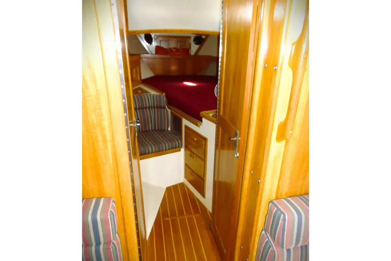 Slide: The Image of Interior of 1997 Pacific Seacraft 37 sailboat with wood finish and striped seating. - 3