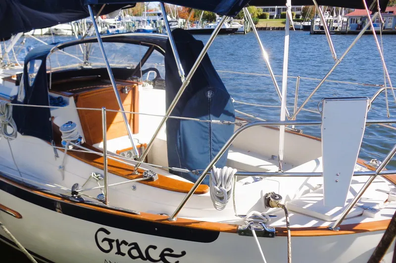 Slide: The Image of 1997 Pacific Seacraft 37 sailboat docked, featuring a clean deck and polished wood accents. - 7