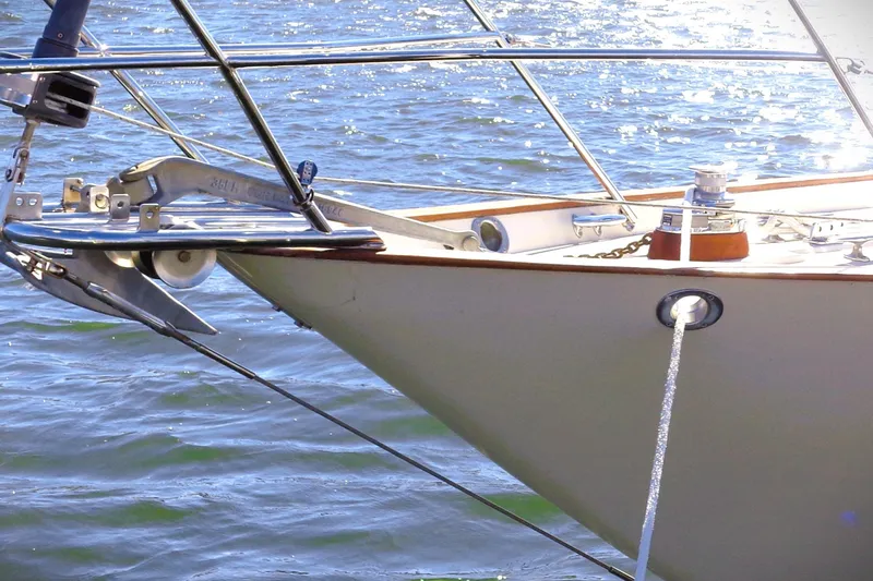 Slide: The Image of Bow of a 1997 Pacific Seacraft 37 sailboat with anchor and rope in water. - 9