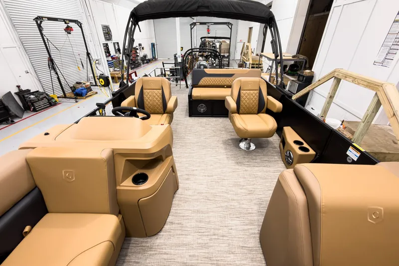 Slide: The Image of 2026 Godfrey Sweetwater 22' Tritoon interior with tan seating and modern design. - 10