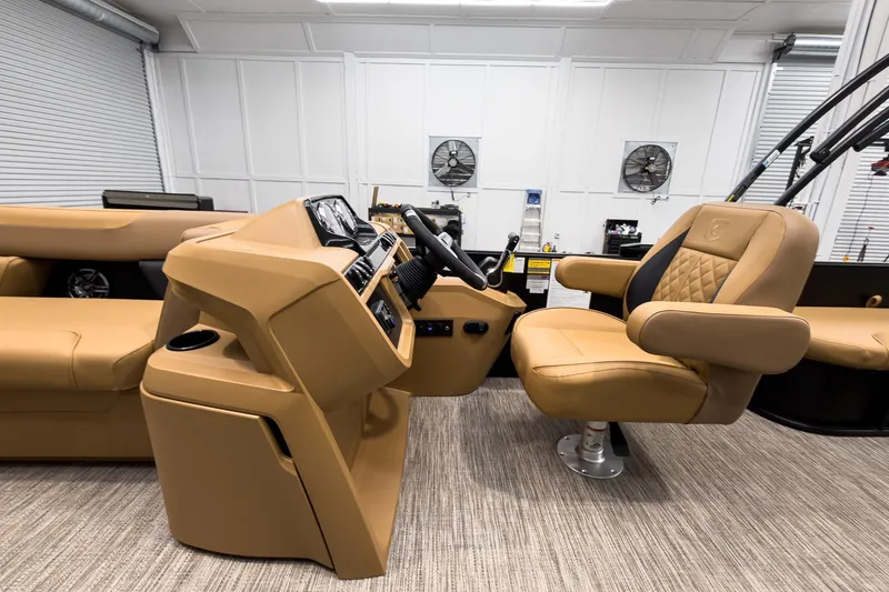 Slide: The Image of Interior of 2026 Godfrey Sweetwater 22' Tritoon, featuring luxurious tan seating and modern controls. - 11