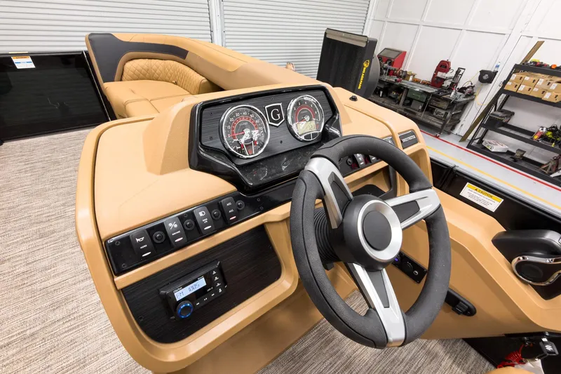 Slide: The Image of 2026 Godfrey Sweetwater 22' Tritoon dashboard with steering wheel and control panel. - 12
