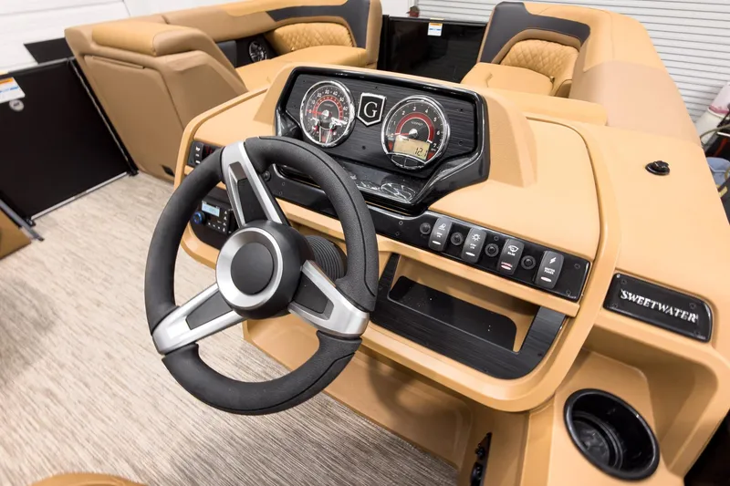 Slide: The Image of 2026 Godfrey Sweetwater 22' Tritoon dashboard with steering wheel and control panel. - 13