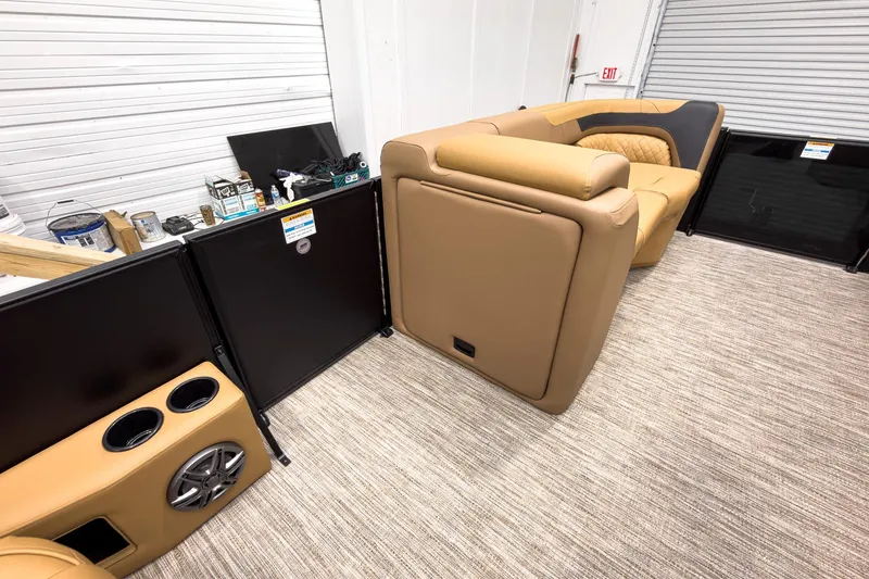 Slide: The Image of Interior of 2026 Godfrey Sweetwater 22' Tritoon with tan seating and cup holders. - 17