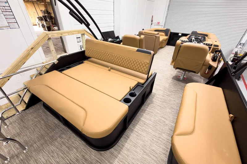 Slide: The Image of Interior of 2026 Godfrey Sweetwater 22' Tritoon with tan seating and modern design. - 21