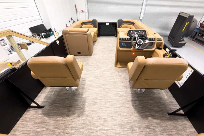 Slide: The Image of Interior of 2026 Godfrey Sweetwater 22' Tritoon with tan seating and modern dashboard. - 23