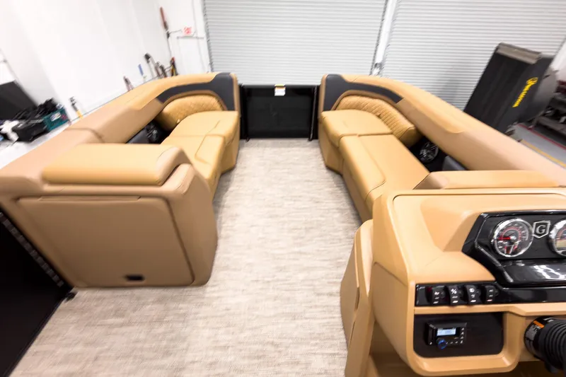 Slide: The Image of Interior of 2026 Godfrey Sweetwater 22' Tritoon with tan seating and modern dashboard. - 24