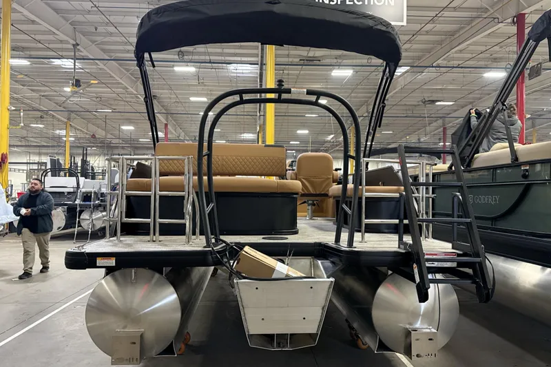 Slide: The Image of 2026 Godfrey Sweetwater 22' Tritoon boat in warehouse, featuring single flip lounge. - 29