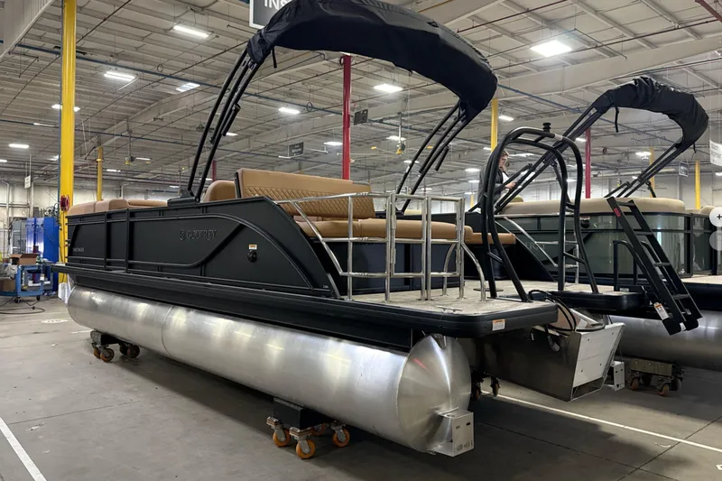 Slide: The Image of 2026 Godfrey Sweetwater 22' Tritoon boat in a warehouse setting. - 30