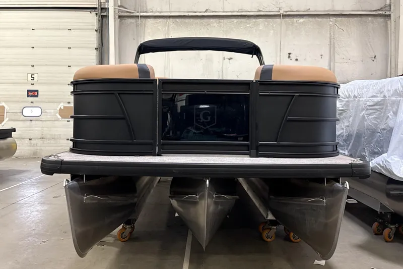 Slide: The Image of 2026 Godfrey Sweetwater 22' Tritoon boat in a warehouse setting. - 33
