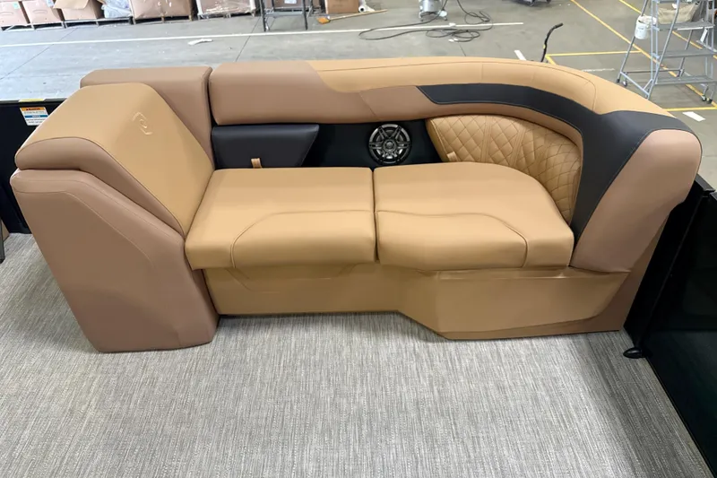 Slide: The Image of Luxurious tan seating on 2026 Godfrey Sweetwater 22' Tritoon, featuring quilted accents and integrated speaker. - 36