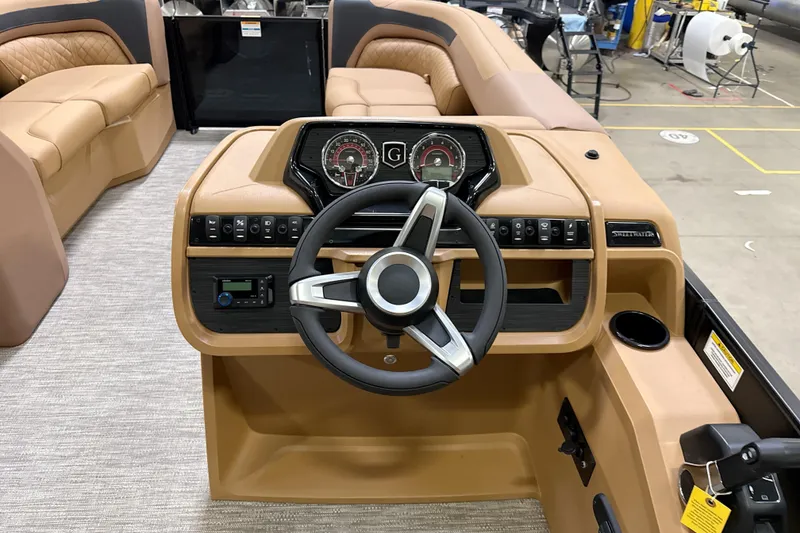 Slide: The Image of 2026 Godfrey Sweetwater 22' Tritoon boat interior with steering console and lounge seating. - 38