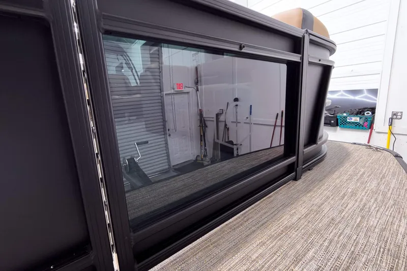 Slide: The Image of 2026 Godfrey Sweetwater 22' Tritoon with sleek black exterior and modern design. - 4