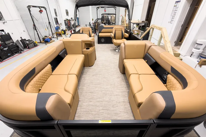 Slide: The Image of Luxurious interior of 2026 Godfrey Sweetwater 22' Tritoon with tan seating and modern design. - 5