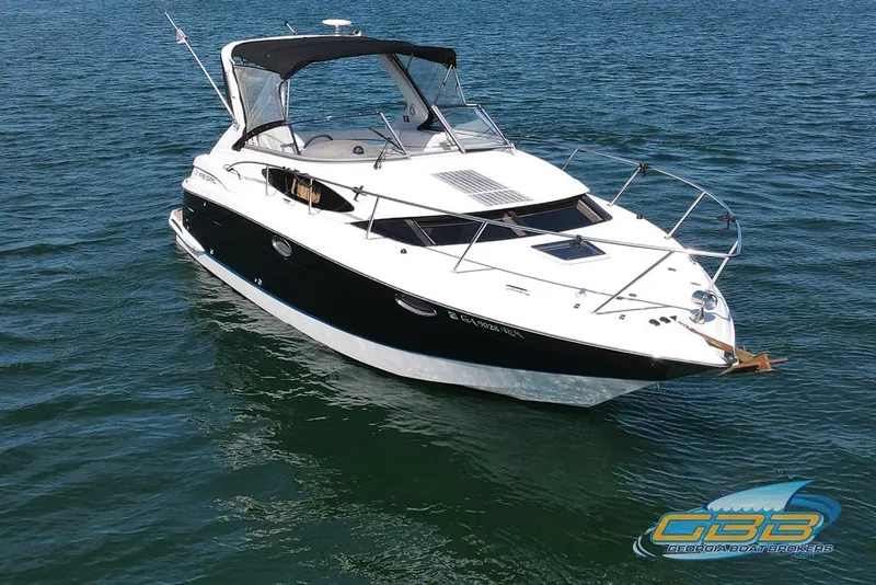 Slide: The Image of 2006 Regal 3060 Window Express boat on calm water, featuring sleek design and canopy. - 10