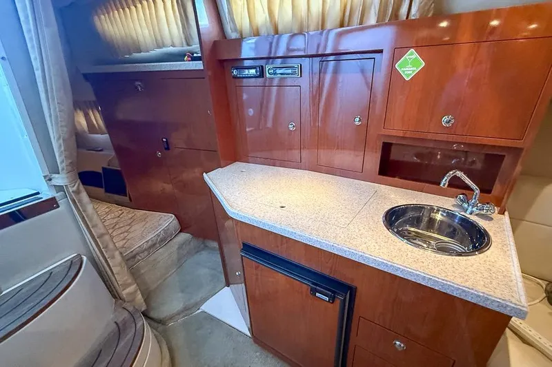 Slide: The Image of 2006 Regal 3060 Window Express cabin interior with kitchenette and seating area. - 14