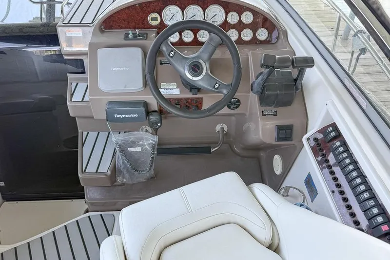 Slide: The Image of Helm of 2006 Regal 3060 Window Express with steering wheel and control panel. - 16