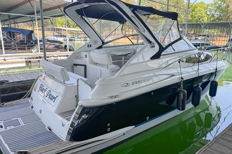 Slide: The Image of 2006 Regal 3060 Window Express boat docked, featuring sleek design and spacious interior. - 17